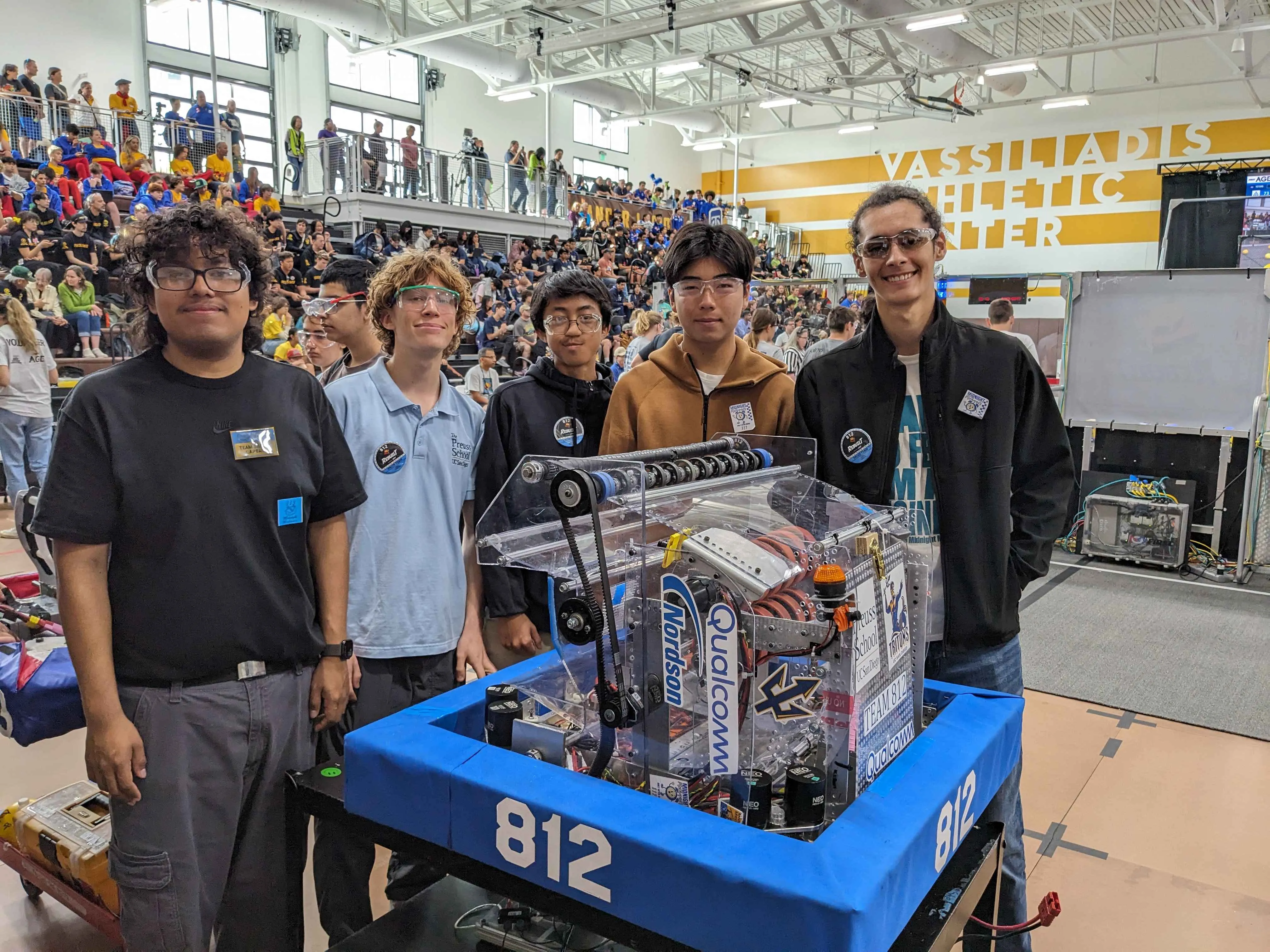 Team 812 members with their competition robot at a REBUILT event.